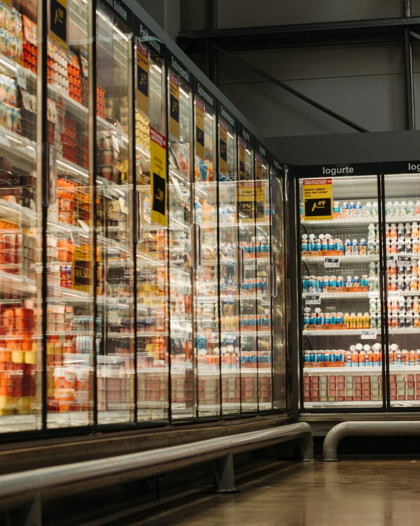 Refrigerated display cases in a Singapore-style supermarket, the first commercial refrigeration category covered by the 2027 GWP 150 rule